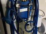 a blue hose attached to a blue machine in a bathroom