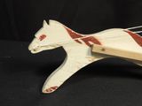 a toy horse that is sitting on a black surface