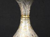 silver and gold vase on a black background with a black background