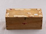 a small wooden box with a tag on it
