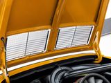 a close up of a yellow car with its hood open