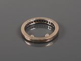 a close up of a gold ring on a black surface