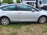 a silver car that is parked in the grass