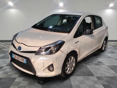 a picture of a white toyota yaris parked on a checkered floor