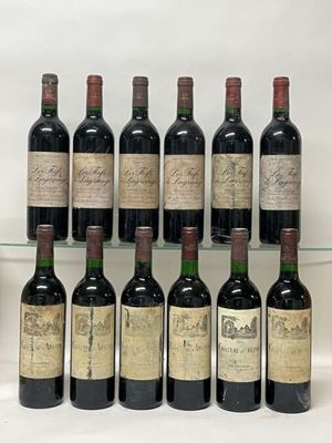 several bottles of wine are lined up on a glass shelf