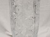 a glass vase on a white cloth with a white background