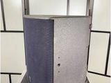 a silver and black speaker sitting on top of a metal case
