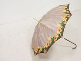 a small umbrella that has yellow flowers on it
