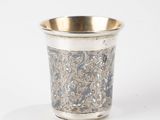 a silver cup that is sitting on a table