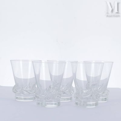 four glasses are lined up on a table with a white background