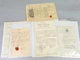 three old letters and a wax seal sitting on top of a table