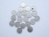 a lot of coins that are on a white surface