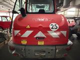 a large red truck that is parked in a garage