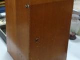 a wooden box sitting on top of a white table