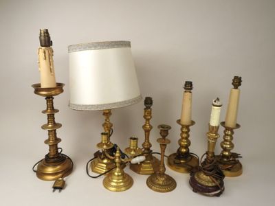 a lot of candles and a lamp on the table