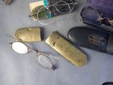 a lot of glasses and a pair of eyeglasses on a table
