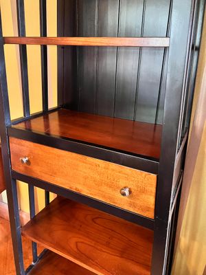 une étagère en bois avec deux tiroirs, dans une pièce