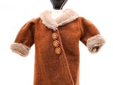 poupée vêtue d'un manteau marron et d'un chapeau à col de fourrure