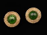 a pair of gold and green jade earrings