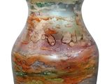a vase that is sitting on a white surface