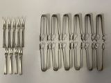 a lot of forks and spoons that are on the table