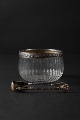 bowl with spoon and spoon rest on a black surface