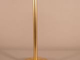 a gold pedestal with a red sign on top of it
