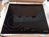 a black glass stove top in a box on a table
