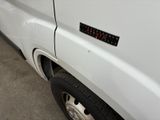 a close up of a white van with a sticker on it