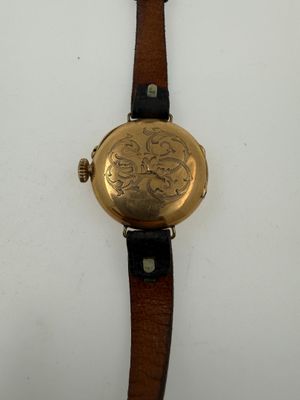 a close up of a watch on a white surface with a white background