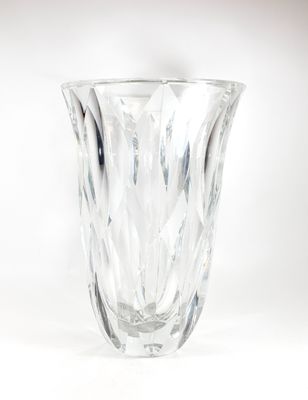 a glass vase that is sitting on a white surface