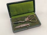 two pairs of scissors in a case on a table