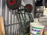 a truck that is parked next to a bucket of paint