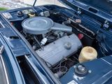 a blue car with a small engine in it ' s trunk