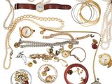 many different types of necklaces and bracelets laid out together