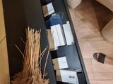 a black shelf with a bunch of boxes and a plant in it