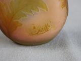 a glass vase with a design on it on a table