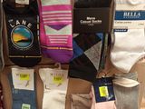 several pairs of men ' s socks are on display in a cardboard box