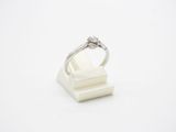 a close up of a diamond ring sitting on top of a white marble block