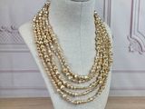 a close up of a necklace on a mannequin on a table
