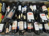 many bottles of wine on display in a glass case