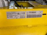 a close up of a yellow machine with a label on it