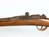 an old rifle with a wooden handle on a white surface