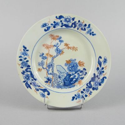 a blue and white plate with a blue and orange design on it