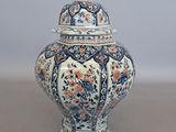 un vase bleu et blanc avec un couvercle posé sur une table