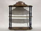 an old wooden shelf with a clock on top of it