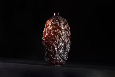 dried dates in a glass jar on a black background