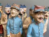 many figurines of people with hats on them