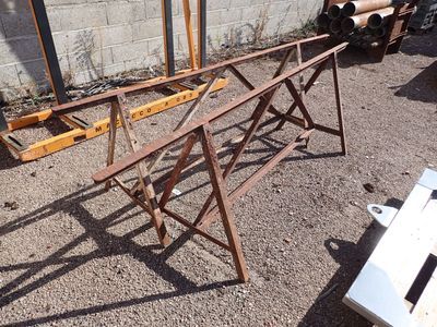 a wooden table that is sitting in the dirt