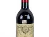 a bottle of red wine sitting on a white surface